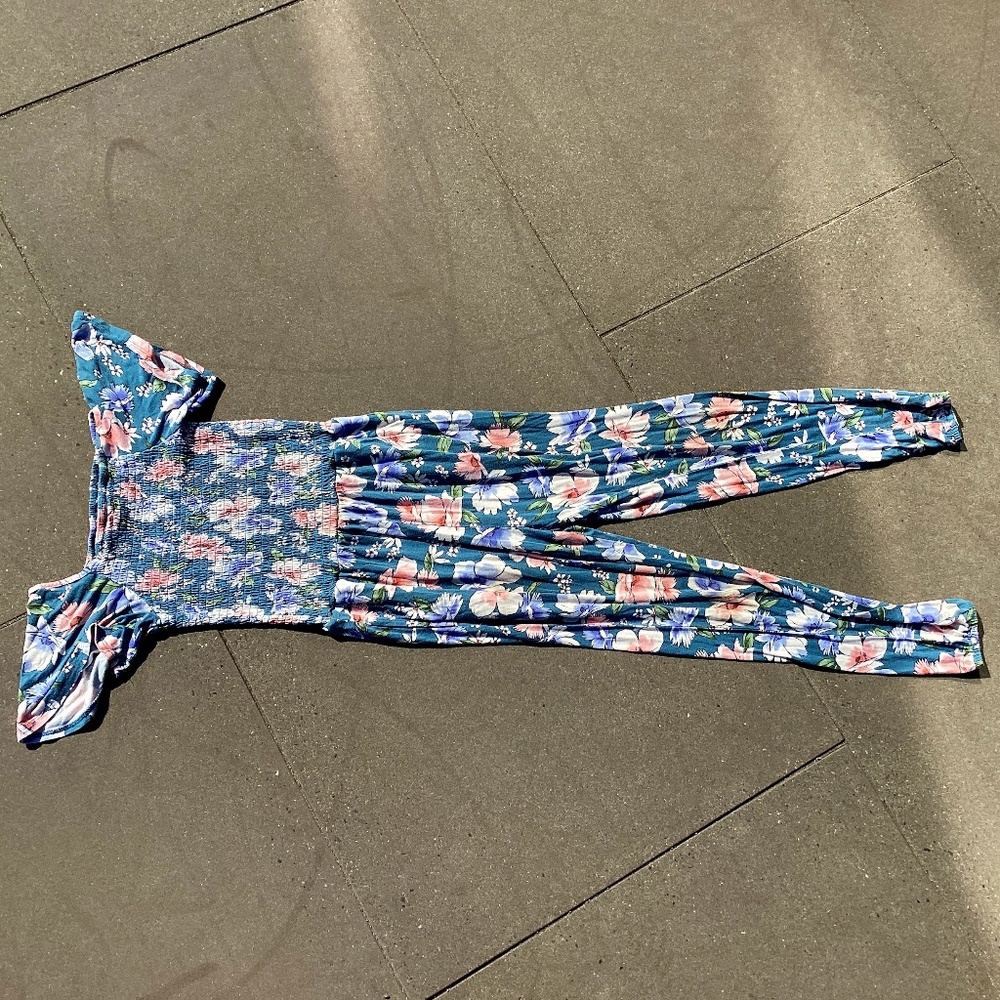 Youth medium, age 8-10 full leg Bailey Lane teal romper with floral designs.